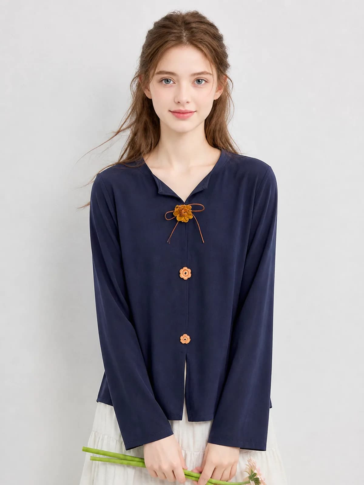 AI clothing photo of a navy blouse with flower-shaped buttons
