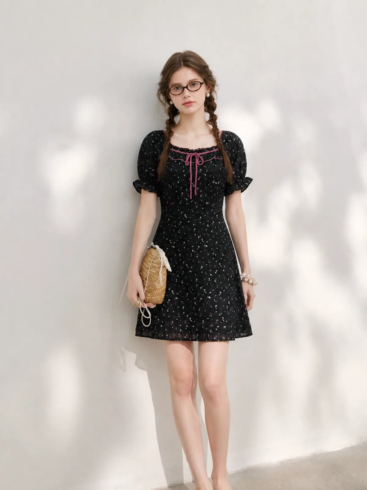 AI model in a black floral puff-sleeve mini dress with a pink neck tie