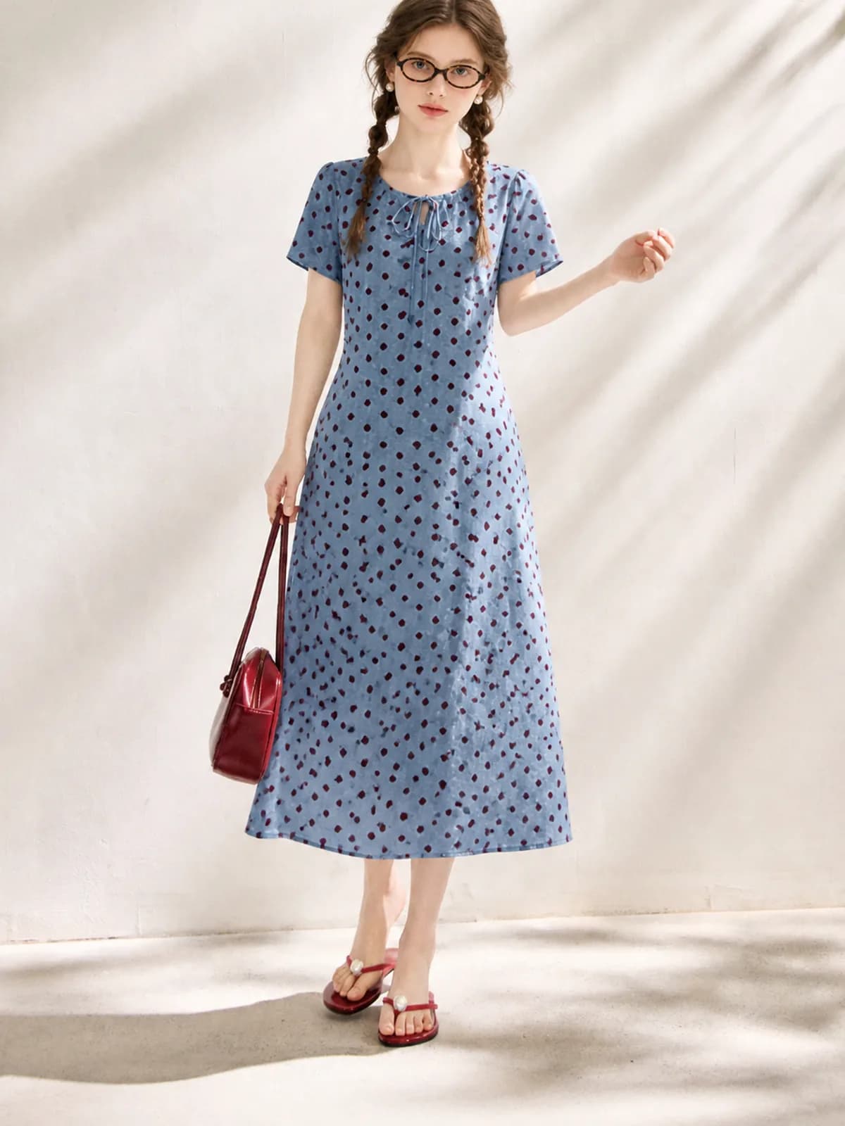 AI fashion model in a blue midi dress with burgundy velvet dots