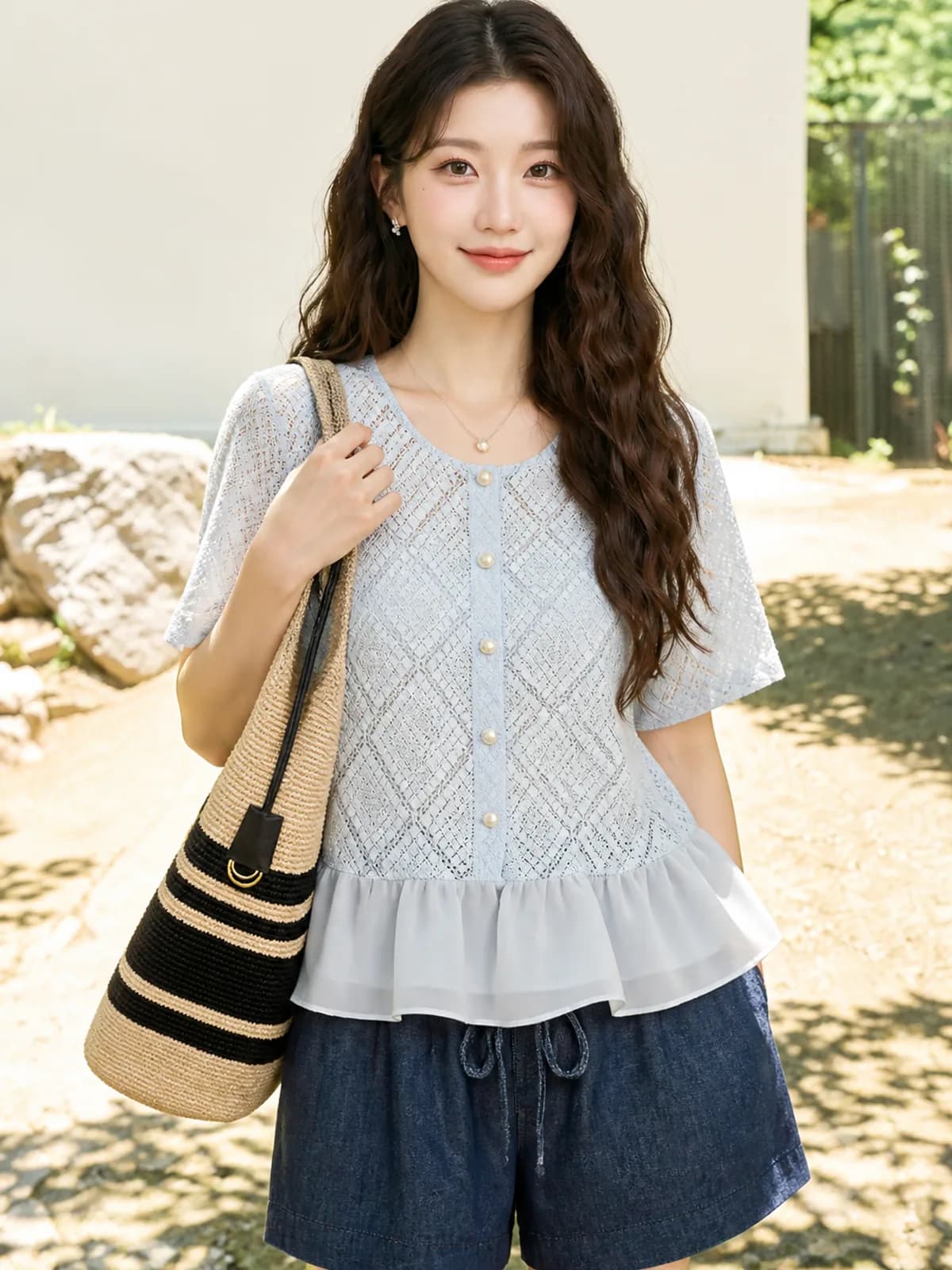 Half-length frame of the pale blue eyelet top showing the eyelet pattern