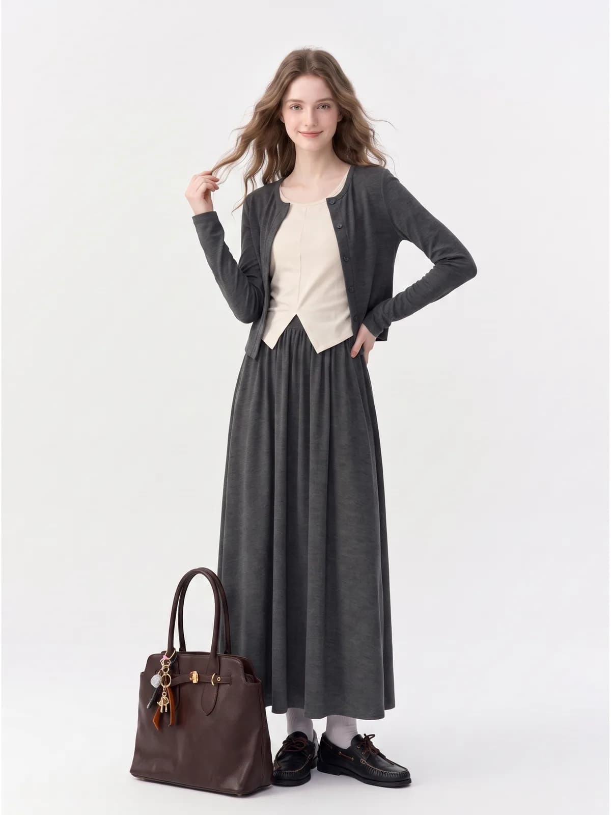 Charcoal cardigan, cream top and charcoal maxi skirt on an AI model, front-facing