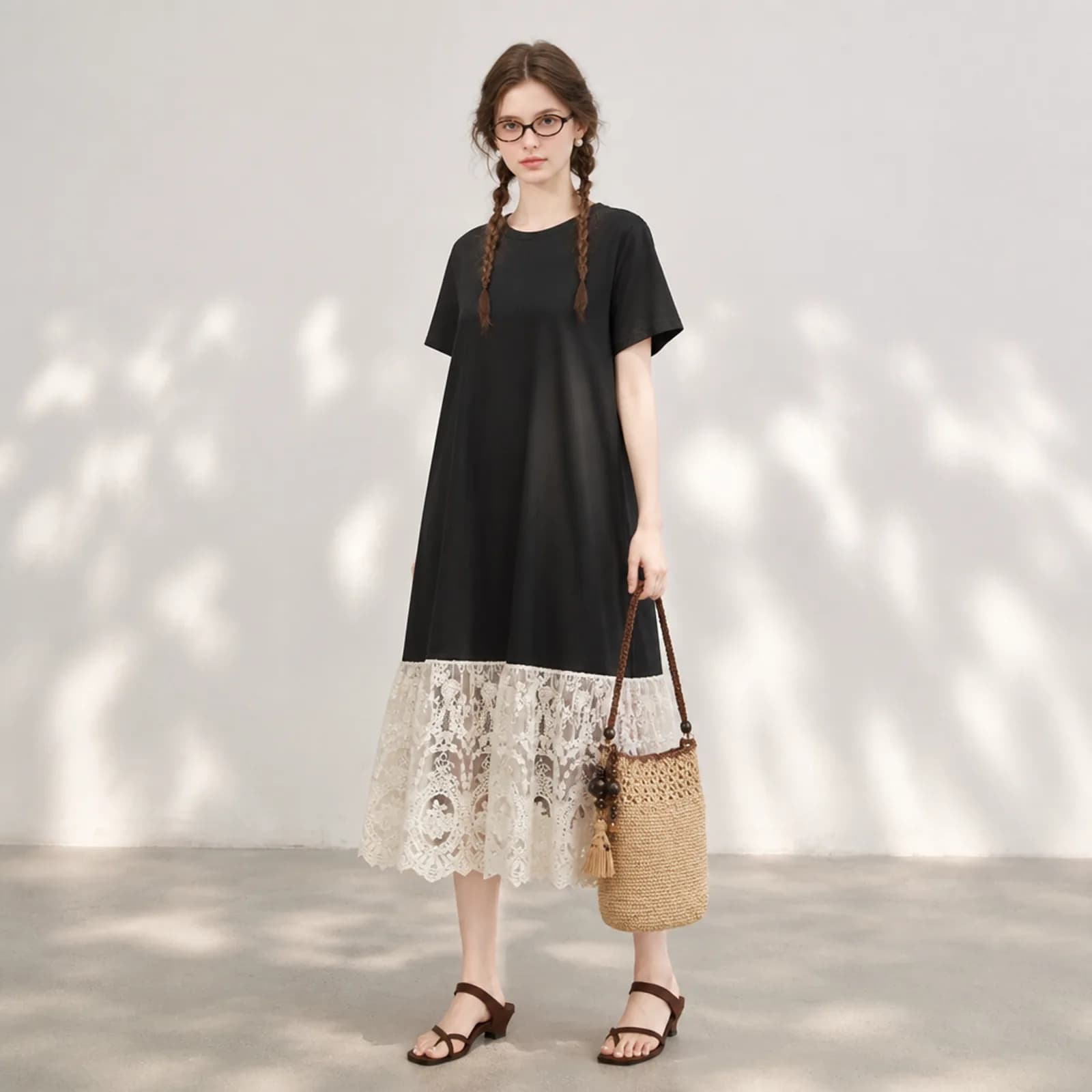 AI model wearing a black T-shirt dress with a deep cream guipure lace hem