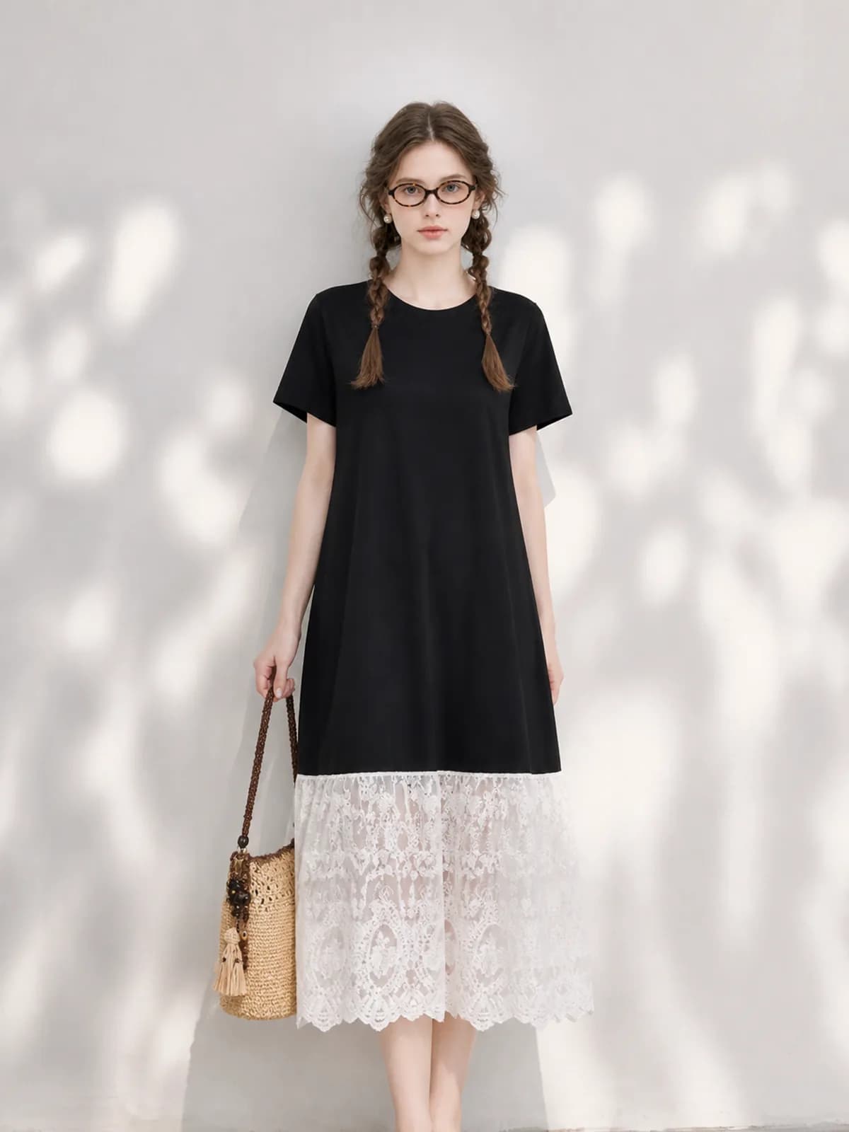 Black T-shirt dress with a cream lace hem on an AI model, front-facing pose