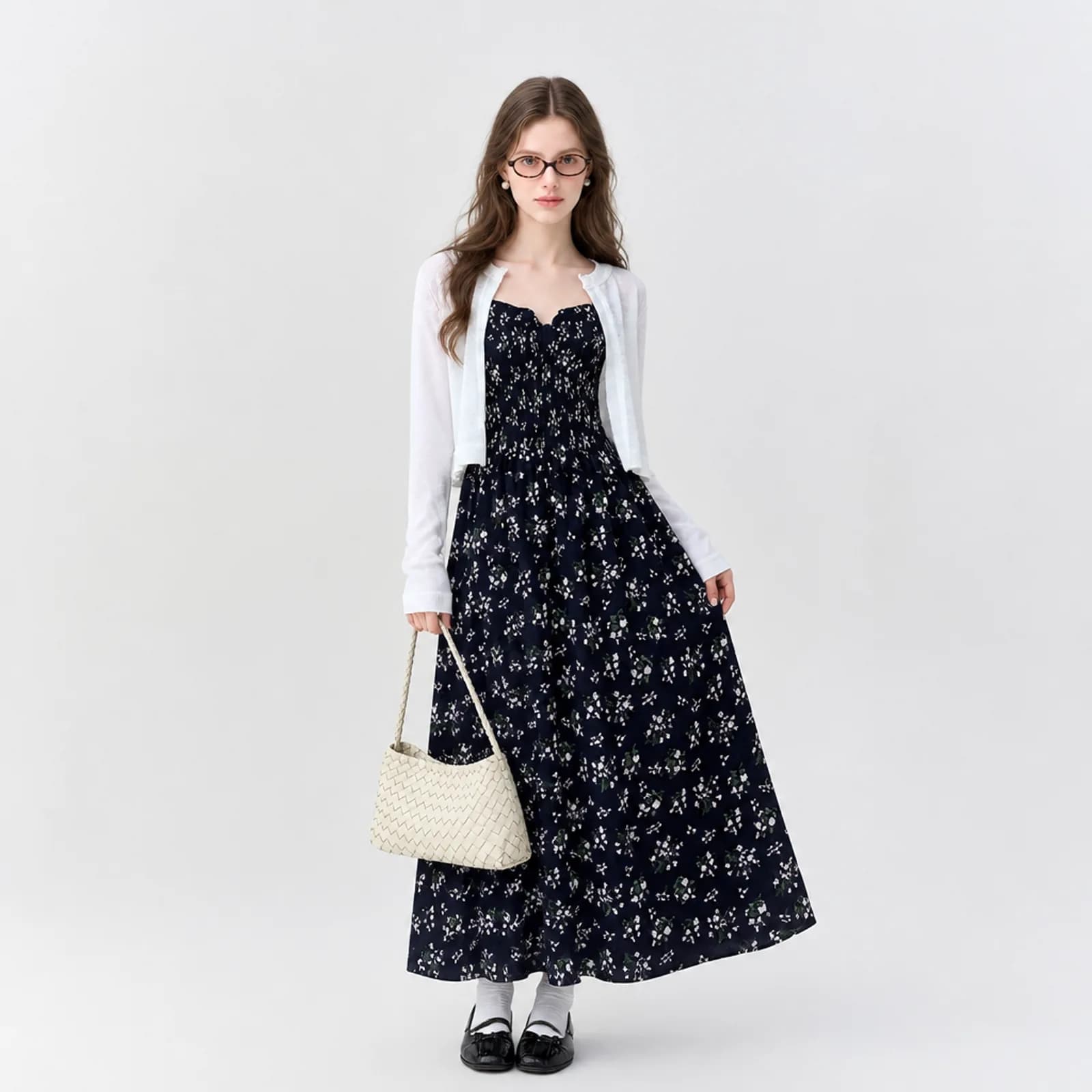 Navy floral maxi dress with white cardigan on an AI model against a white background