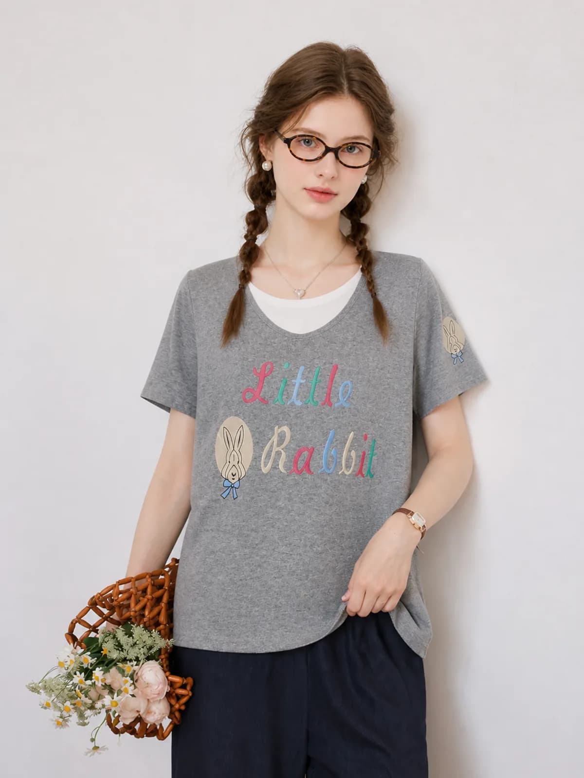 Grey marl tee with a rabbit embroidery on an AI model, thrift reseller listing photo